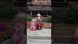 Miao Köyü Çin. Turistler geleneksel kıyafetleri giyerek Miao kültürünü deneyimliyor.