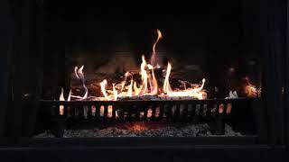 Burning Fireplace with slow crackling Fire.  Wooden log surrounded by orange and blue flames