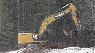 CAT 324E digging topsoil and loading a Volvo BM A25C