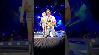 Darci Claire singing with Luke Bryan