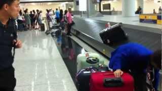 Baggage handler throwing luggage around in Hong Kong airport