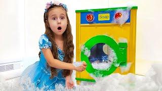 Milana pretend plays being a mother to Baby Dolls & toy washing machine