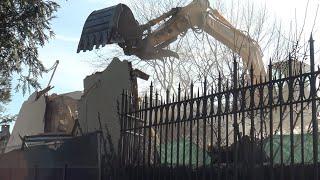 Final Walls of a historic lakefront estate gate-house being demolished