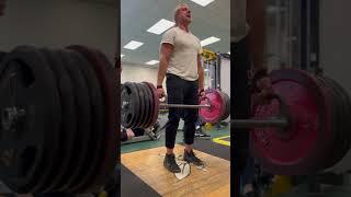 Finishing the 40th and final rep as man in background crawls out from inside the leg press