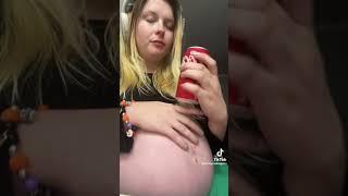 Burping babe with massive pregnant belly 