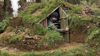 Building complete and warm survival shelter  Bushcraft earth hut grass roof & fireplace with clay