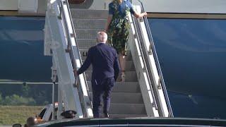 President Joe Biden climbs steps to Air Force One at HIA