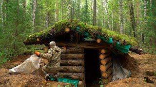 Construction of an underground shelter in a wild forest. A man builds a dugout alone