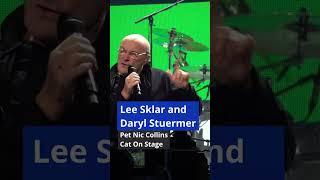 Lee Sklar and Daryl Stuermer pet Nic Collins cat on stage ⬘ Sept 24 2019 ⬘ Houston TX