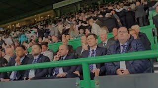 Celtic Fans Do The Huddle In Front Of Depressed Looking Rangers Board