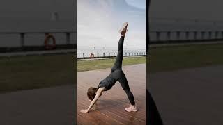 A Woman With Good Flexibility Stretching Outdoors On Grassy Lawn  Down Dog to Lunge  gym yoga