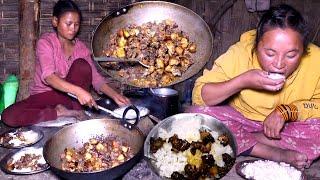 Young girls are cooking and eating pork meat curry in rural Nepal  Local pork curry cooking