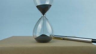 Closeup shot of sand running through an hourglass with a pile ...  Indian Stock Footage  Knot9