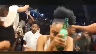 Girl dancing while sucking on a bottle