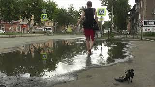 Girl and women walking barefoot in puddle