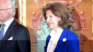 King Carl Gustaf and Queen Silvia of Sweden handing out medals