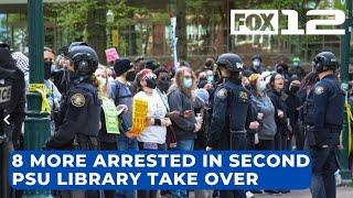 Police arrest 8 more after protesters rip down barricades break into PSU library again