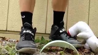 Boy crushing teddy bear with Nike shoes and elite socks. Hot smelly feet