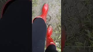 Wife in hunter rubber boots with black tight legging playing in the mud after dinner