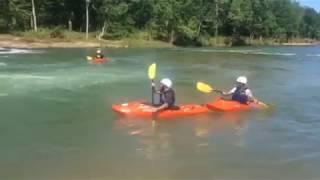 Kayakers ride waves at the Siloam Springs Kayak Park