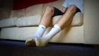 Young male in sweaty white Nike socks and Nike SB sneaks