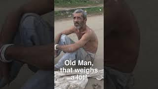 An Old Man Drags Heavy Stones to Prove His Faith