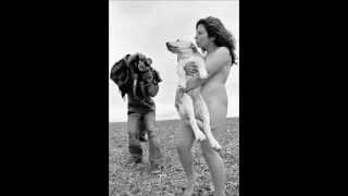 naked woman holding a dog