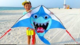 Fun family trip Sofia and Max play with a kite on the beach