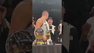 Nikola Jokić gets tight with his teammates for smacking him while hes accepting his WCF trophy ..