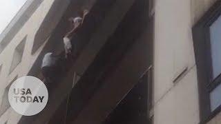 Spiderman in Paris Migrant scales building to save child