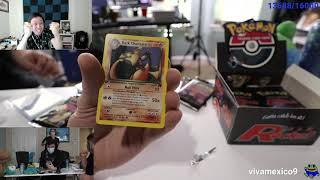 Train unboxes a holo charizard card in a 1st edition booster pack