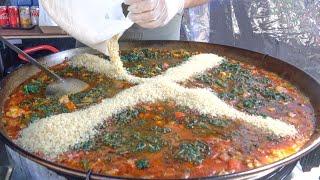 Spanish Paella with Pork Sausages Rice and Spinach. London Street Food