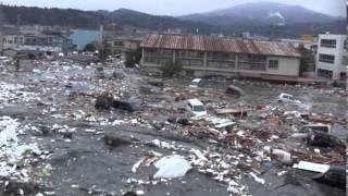 Tsunami in Kesennuma city ascending the Okawa river