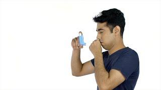 Young asthma patient using a medical spray against the white b...  Indian Stock Footage  Knot9