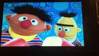 Play with me sesame Ernie says while Bert is holding a piece of cheese