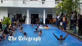 Protesters swim in the Sri Lankan presidents pool after storming his home