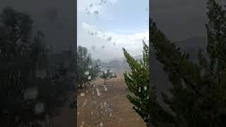 30 seconds of rain on a metal roof with mountain view.