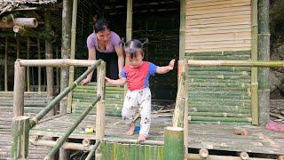 Girl building bamboo walls for the house - single mother