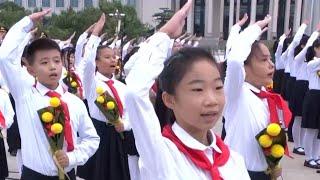 Children sing We Are the Successors of Communism to mark Martyrs Day