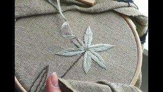 Gray flowers on pure linen fabric. Embroidery for beginners