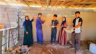 Family solidarity Plastering the walls of the house with the cooperation of Mohammad