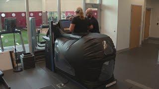 Monica Robins demonstrates anti-gravity treadmill at UH Drusinsky Sports Medicine Institute