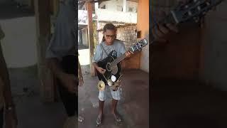 Street artist playing Bob Marley in Brazil with a cool instrument