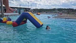 All 4 kids make it across the pool inflatables at Park Falls Pool