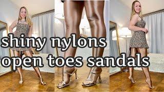 unpacking new tights. Try on new shiny pantyhose with golden sandals. Ideas for outfits.