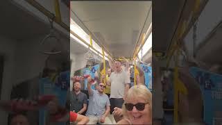 FC United of Manchester manager and fans singing on the Milan Metro after playing at the San Siro