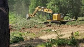 Clearing stumps with Cat 320 excavator