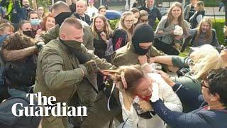 Women tear balaclavas off security officers amid mass arrests in Belarus