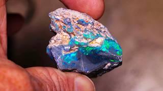 Beating the unrelenting inclusions in this rough opal - Incredible outcome.