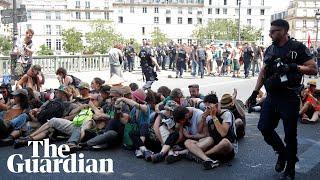 Police use pepper spray on seated climate protesters in Paris